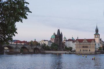 Prague cityscape in spring. View of old city center from the opposite bank of Vltava river after sunset