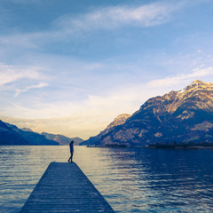 Enjoying nature alone. Small female figure in the epic mountain landscape