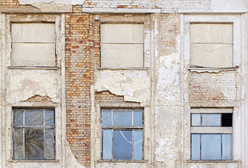 Fototapeta na wymiar abandoned grunge cracked stucco wall with with boarded up window
