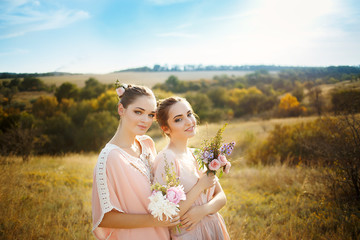 bridesmaids in pink dresses with bouquets