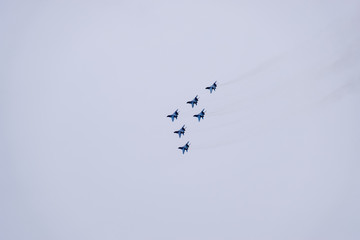 Air show in the sky above the Krasnodar airport flight school. Airshow in honor of Defender of the Fatherland. MiG-29 in the sky.