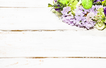 Background for easter, card with eggs and flowers on white table, home decor