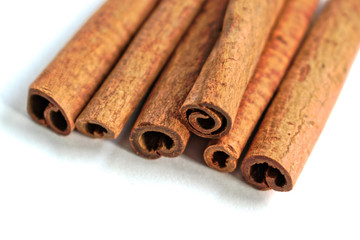 Closeup of cinnamon sticks on a white background