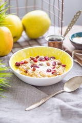 Oatmeal with Bananas, Apples, Raisins and Almonds for Breakfast, Vertical View