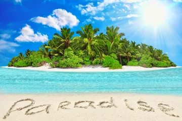 Foto op Plexiglas Whole tropical island within atoll in tropical Ocean and inscription "Paradise" in the sand on a tropical island. © BRIAN_KINNEY