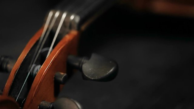 extreme close up panoramic shot of part of aged violin on black background