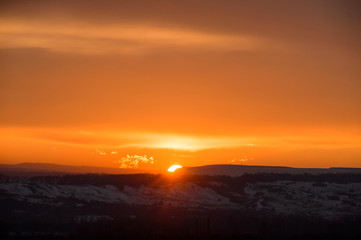 Sunset sky with the sun, with gold clouds