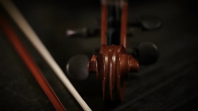 extreme close up panoramic shot of part of aged violin on black background