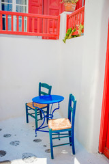 Outdoor cafe on street of typical greek traditional village on Mykonos Island, Europe