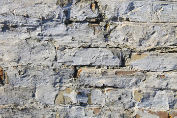 Background of old vintage dirty brick wall with peeling plaster