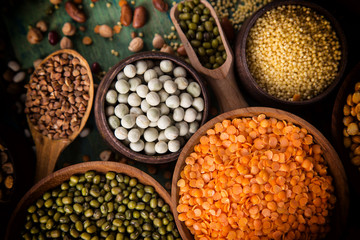 Raw legume on old rustic wooden table.