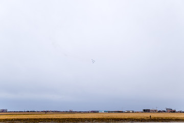 Air show in the sky above the Krasnodar airport flight school. Airshow in honor of Defender of the Fatherland. MiG-29 in the sky.