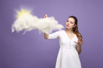 Woman with cloud and sun. Concept on the topic of computer cloud services.