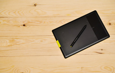 Graphic tablet on a wooden background