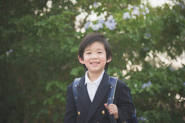 Asian student with backpack look up