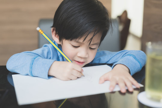  Asian Child Writing On White Paper