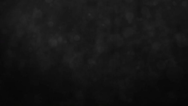 Abstract black smokey background with floating particles. Seamlessly loopable animation.