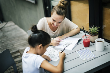 Woman And Girl Doing Homework Concept
