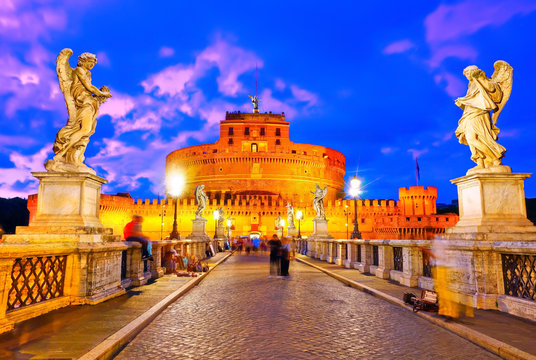 View of the Castel Sant'Angelo on the Aelian Bridge in Rome at dusk.