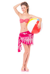 Pretty girl posing in pink bikini with beach ball, isolated on white background