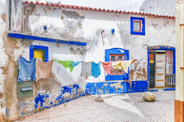 drying laundry in Nazare. Portugal - obrazy, fototapety, plakaty
