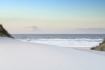 White dunes with view of the ocean and blue sky
