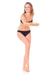 Fototapeta premium Happy young woman in a black bikini with flying disc, isolated on white background 