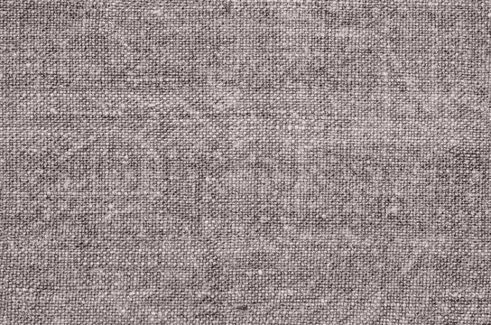 Homespun hemp cloth. Close-up of texture fabric cloth textile background. Homespun hemp fabric material. Homespun hemp canvas. Natural authentic cloth. Gray-green color