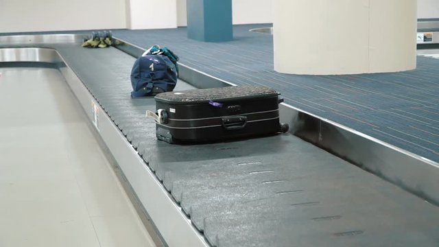 Luggage travels on a conveyor belt at the airport. Full HD stock footage.
