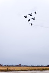 Air show in the sky above the Krasnodar airport flight school. Airshow in honor of Defender of the Fatherland. MiG-29 in the sky.