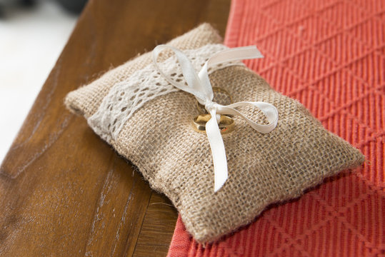 Two wedding rings tied in a sackcloth pad