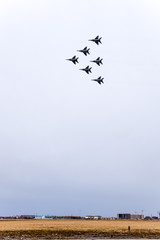 Air show in the sky above the Krasnodar airport flight school. Airshow in honor of Defender of the Fatherland. MiG-29 in the sky.