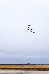 Air show in the sky above the Krasnodar airport flight school. Airshow in honor of Defender of the Fatherland. MiG-29 in the sky.