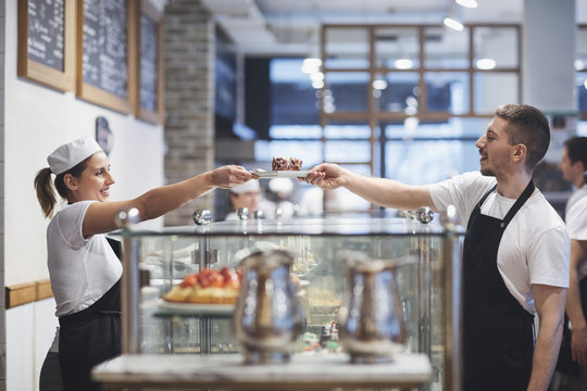 Bartender and waiter working together at coffee shop