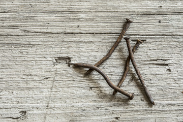 Obraz premium Rusty nails on wooden background