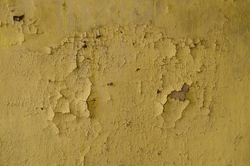 Texture of yellow shabby wall in abandoned building