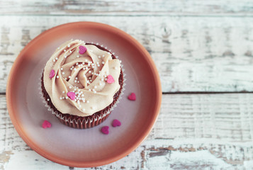 Chocolate cupcakes decorated with cream rose hearts