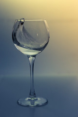 Splash water in a glass on a gray background