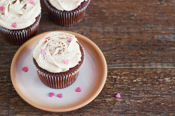 Chocolate cupcakes decorated with cream rose hearts
