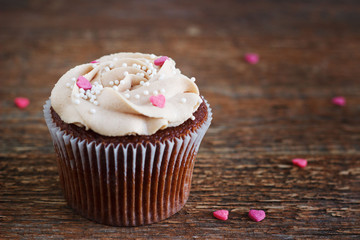 Chocolate cupcakes decorated with cream rose hearts