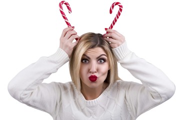 Make faces. A young woman,blonde with caramel candy.To put the horns.To have fun and indulge.