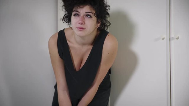 upset , depressed woman in a skirt crying desperately