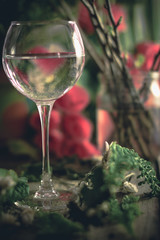 A glass of water on the flowers and plants against