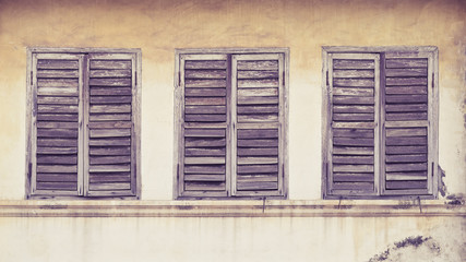 The Old window on wall background. Vintage color style.