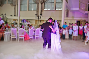 Awesome first wedding dance with smoke and rose purple lights.