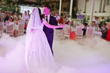Awesome first wedding dance with smoke and rose purple lights.