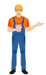 Builder holding a piggy bank and nd showing something beside of him