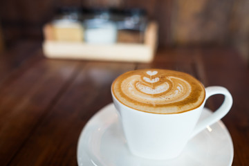Coffee latte art on wood table.
