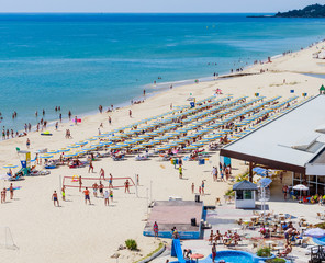 The Black Sea shore, blue clear water, beach with sand, umbrellas and sunbeds. Albena, Bulgaria