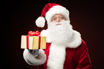 Santa Claus with gift box in hand